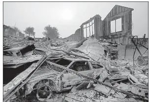  ?? AP/The Sacramento Bee/PAUL KITAGAKI JR. ?? Smoke rises over a burned home Tuesday in Sonoma County, Calif.