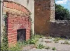  ?? JERRY HARMER — THE ASSOCIATED PRESS ?? This July 8, 2018 photo, shows the remains of a fireplace and a missing window, in a ruined cottage in Tyneham, in Dorset, England. The village was commandeer­ed by the military in 1943 and the people evacuated. They were never allowed back and Tyneham remains in the hands of the Ministry of Defense. The village dwellings have slowly fallen apart, as waether rotted the roof beams and upper floors and nature reclaimed the interiors.