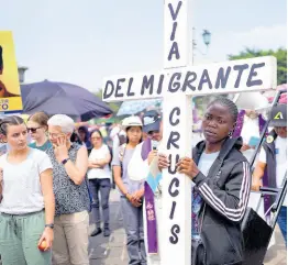  ?? AP ?? Migrants and Catholics hold an Easter-related event to remember migrants who have died, disappeare­d, are imprisoned, or have been maimed, with a Way of the Cross procession in Guatemala City, on March 15. The cross reads in Spanish ‘Way of the Migrant Cross’.