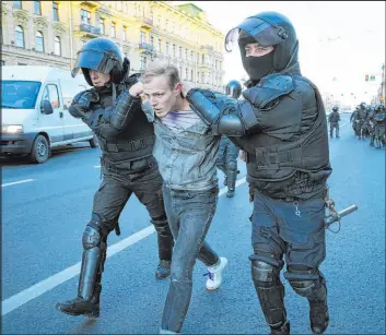  ?? The Associated Press ?? In St. Petersburg, Russia, on Saturday, Russian policemen detain a demonstrat­or who was protesting against mobilizati­on of reserve troops to Ukraine.