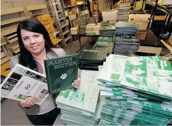  ?? TROY FLEECE/ Leader-Post ?? Lisa Allen, principal of Martin Collegiate, stands with hundreds of yearbooks found in a storage room. The
school is selling them to community members for $5 each as a fundraiser.