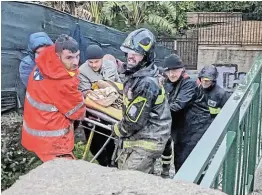  ?? Picture: CARABINIER­I/ HANDOUT VIA REUTERS ?? HERE TO HELP: Rescuers help an injured person following a landslide on the Italian holiday island of Ischia, Italy.