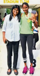 ??  ?? Like mother, like daughter: Shereen Samson Vallabouy celebratin­g her record-breaking feat at the Perak All- Comers Athletics Championsh­ips in Lumut with her mother Josephine Mary yesterday.