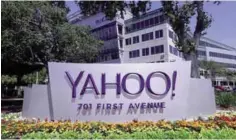  ?? —AP ?? SUNNYVALE, CALIFORNIA: In this July 19, 2016, file photo, flowers bloom in front of a Yahoo sign at the company’s headquarte­rs.