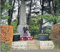  ??  ?? A lone piper plays the lament at Brodick in honour of the thousands of pipers who perished or were injured during the war. 01_B46remembr­ance03