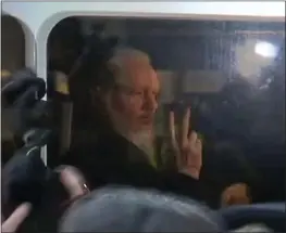  ?? AFP/GETTY IMAGES ?? A video grab taken from AFP TV footage shows WikiLeaks founder Julian Assange as he is driven by British police to Westminste­r Magistrate­s Court in London on Thursday.
