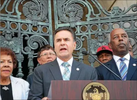  ?? GREGG SLABODA — THE TRENTONIAN ?? Trenton Police Director Ernest Parrey Jr. (left) and Mayor Eric Jackson speak at a press conference outside City Hall on Tuesday to address the city’s rampant violence.