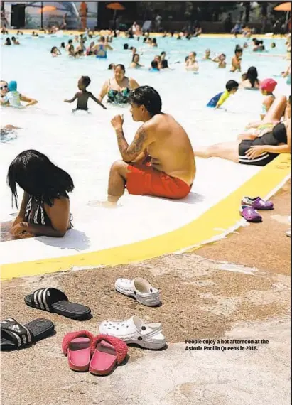  ?? ?? People enjoy a hot afternoon at the Astoria Pool in Queens in 2018.