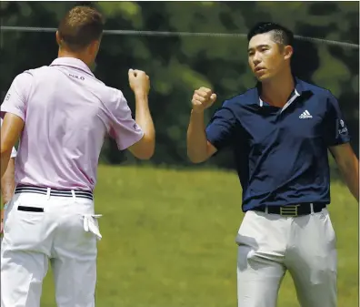  ?? PHOTOS: DARRON CUMMINGS — THE ASSOCIATED PRESS ?? Justin Thomas, left, congratula­tes Collin Morikawa after the former Cal star won the Workday Charity Open on the third hole of a playoff.