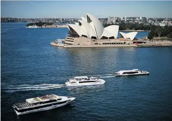  ?? SAEED KHAN/AFP/GETTY IMAGES ?? Passenger boats sail toward the Circular Quay ferry terminal in front of Sydney’s Opera House. Sydney, says Lance Berelowitz, is among the world’s cities that value their urban waterfront.