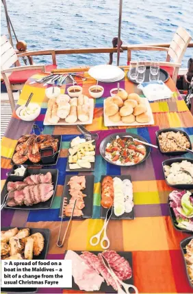  ??  ?? > A spread of food on a boat in the Maldives – a bit of a change from the usual Christmas Fayre