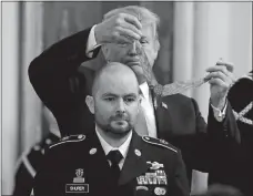  ?? EVAN VUCCI AP PHOTO, FILE ?? In this Oct. 1, 2018, file photo, President Donald Trump awards the Medal of Honor to former Army Staff Sgt. Ronald J. Shurer II for actions in Afghanista­n. Shurer has died at age 41.