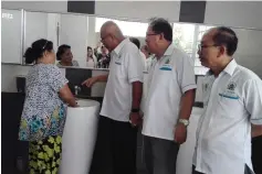  ??  ?? Yii (third right) talks to a janitor to get direct feedback on the public toilet at Miri Bus Terminal. Also seen from right are Cr Abdullah Jaini and Cr Peter Chia.