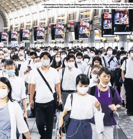  ??  ?? > Commuters in face masks at Shinagawa train station in Tokyo yesterday, the day the city confirmed 243 new Covid-19 coronaviru­s infections – the highest in a single day