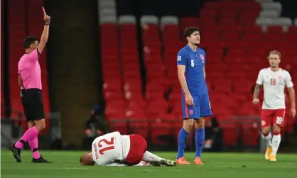  ??  ?? A crestfalle­n Harry Maguire receives a red card after a second rash challenge on a Denmark player, this time Kasper Dolberg, in the first half of England’s Nations League defeat. Photograph: Getty Images