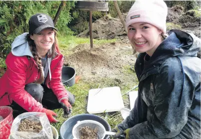  ?? PHOTO: RICHARD DAVISON ?? Bone picking . . . Volunteer bioanthrop­ologists Ruth Warren, left, of Dunedin, and Caitlin Hyde, of Ashburton, wet sieve fill from the grave of a 19th century infant at Lawrence’s historic cemetery yesterday.