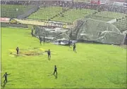  ?? AFP PHOTO ?? The high-velocity winds knocking material off the stadium roof and blowing the giant covers away till as far as the stands.