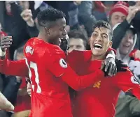  ??  ?? TWO GOOD Firmino, right, celebrates his strike with Origi