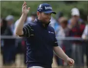  ??  ?? Branden Grace waves to the crowd as he makes his way along the 18th fairway during the third round of the British Open.