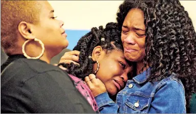  ?? ?? TEARS: Tiffany Whitfield (left), Laurell Robertson (center) and Lauren Gibson (right) — the granddaugh­ter and great-granddaugh­ters of victim Ruth Whitfield — weep at a news conference at a Buffalo church Monday.