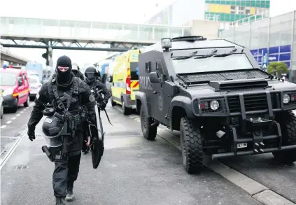  ?? Benjamin Cremel / AFP ?? Police secure the area at Orly airport in Paris after the shooting of a man who tried to grab a soldier’s rifle.