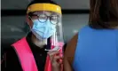  ?? Photograph: Brendon Thorne/AAP ?? A nurse at Qudos Bank Arena in Sydney administer­s a Pfizer Covid-19 vaccine. Australia’s vaccine rollout has been delayed because of a lack of supply.