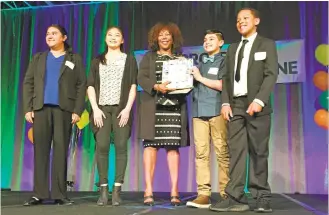  ?? SAL PIZARRO/STAFF ?? Ruby Bridges, center, poses with her Spark award and students, from left, Anushka Sanyal, Jocelyn Maeyama, Brian Sawaya and Aderian Adelabu on Friday at the Project Cornerston­e Asset Champions Breakfast.