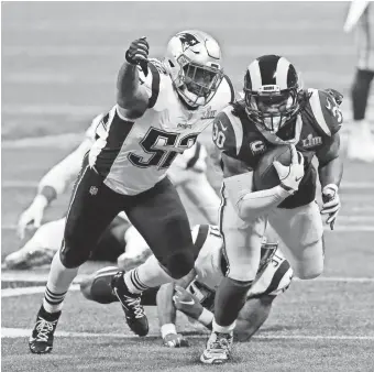  ?? BRETT DAVIS/USA TODAY SPORTS ?? Todd Gurley is chased by Elandon Roberts during the fourth quarter in Super Bowl LIII at Mercedes-Benz Stadium.