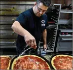  ??  ?? Scott Mezzapeso got $22 an hour at Magna, a GM supplier, but was laid off last summer as GM cut Chevy Cruze production. Now he makes $11 an hour part time at Bruno Bros. Pizza.