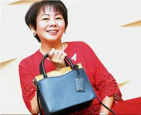  ??  ?? Winner of the ‘Bag That Bag’ competitio­n, Gina Eng Lee Cheng. Trendy arm candy: