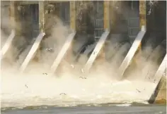  ?? STAFF FILE PHOTO BY TIM BARBER ?? Spillways at the Chickamaug­a Dam create spray that has frozen on the supports as gulls circle in January 2014.