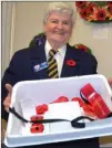  ?? ANDREA PEACOCK/The Okanagan Weekend ?? Joy Wallace, poppy office manager for the Kelowna Legion, holds a tray of poppies on the first day of the poppy campaign, which runs until Nov. 10.