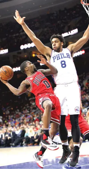  ?? | CHRIS SZAGOLA/AP ?? Bulls guard Aaron Brooks, who had only two points, tries to get a shot off against Philadelph­ia 76ers center Jahlil Okafor in the first half Thursday night.