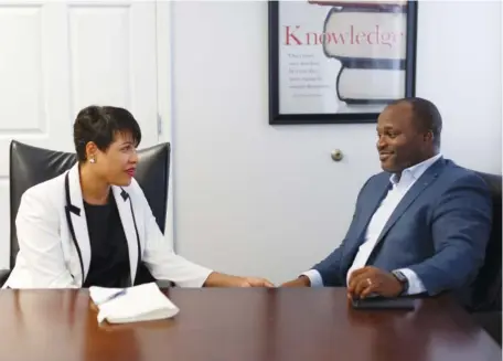  ?? STAFF PHOTOS BY DOUG STRICKLAND ?? Hamilton County Schools Superinten­dent Bryan Johnson holds hands with his wife, Candy, as they talk about their first year in Hamilton County.