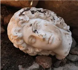  ?? ?? LEFT: The head of a marble statue of Alexander the Great unearthed in the ruins of a second century theatre in northwest Turkey.