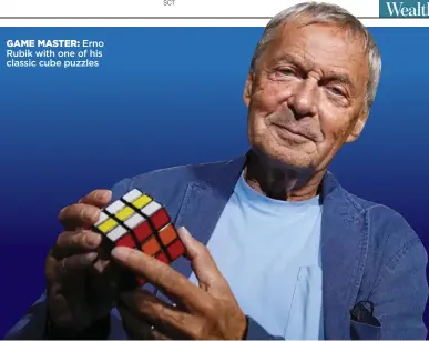  ?? ?? GAME MASTER: Erno Rubik with one of his classic cube puzzles