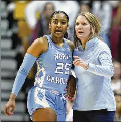  ?? DARRON CUMMINGS/AP 2022 ?? North Carolina coach Courtney Banghart talks with Deja Kelly during a game this season. With Duke rising to No. 9 in this week’s AP Top 25, it marks only the second time since 2000 that each of neighborin­g schools Duke, North Carolina and N.C. State cracked the top 10 in the same season.