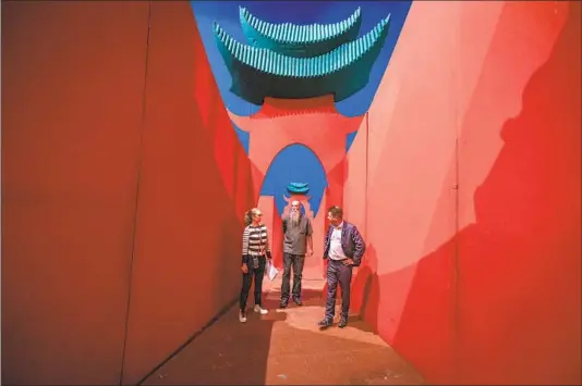  ?? Jason Armond Los Angeles Times ?? A SET designed by David Hockney is a bold backdrop for L.A. Opera’s Carolina Angulo, Jeff Kleeman, center, and Rupert Hemmings during a “Turandot” rehearsal.