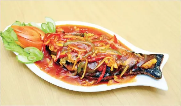  ?? HONG MENEA ?? Meat substitute is moulded into a fish shape to create one of JC Vegetarian’s most popular offerings.