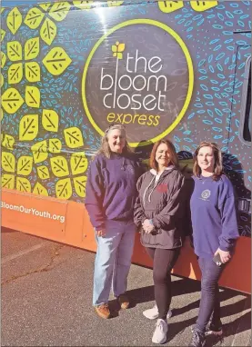  ?? Contribute­d ?? Polk County DFCS staff members Jane Cavaness (from left), Dawn Sanford and Beth Newman stand outside of The Bloom Closet express truck during its visit to the office last month.
