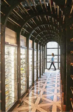  ??  ?? Made from burnt wood and brass, the 2.7m-tall wine cellar in all-day-dining restaurant Leonie’s can hold up to 750 bottles. — Photos: ST