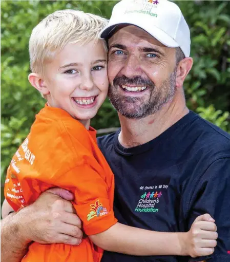  ?? Photo: Renae Droop/ RDW Photograph­y ?? READY TO GO: Senior Constable Chris Hay with son Lachlan. Snr Const Hay departs on his challenge to visit 48 US states in 48 days today.