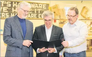  ?? SUBMITTED PHOTO ?? Sandy MacDonald, Holland College’s vice president of academics and applied research, from left, looks over material for the new National Building Code course with Richard Brown, minister of Communitie­s, Land and Environmen­t, and Sam Sanderson,...