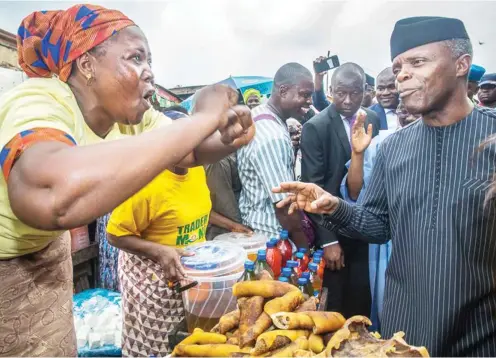  ?? Photo: VP’s Office ?? Vice President Yemi Osinbajo with a trader, during his visit to Bodija and Oje markets in Oyo State yesterday, to interact with beneficiar­ies of the Federal Government’s N10,000 collateral- free loan ‘Trader Moni’