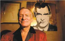  ?? Ann Johansson / Special to The Chronicle 2003 ?? Hefner, the pipe-smoking hedonist garbed in his telltale silk pajamas, poses in 2003, 50 years after Playboy’s first issue.