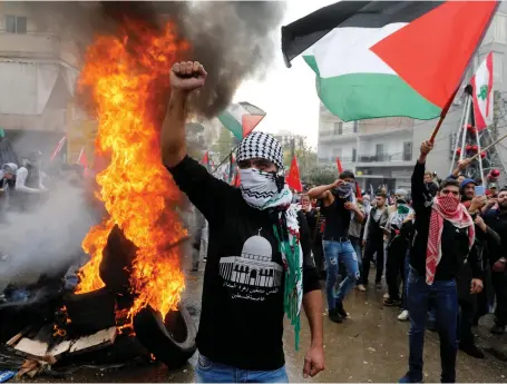  ?? Reuters ?? Protesters set tyres on fire near the US embassy in Lebanon during a demonstrat­ion yesterday against US president Donald Trump’s decision to recognise Jerusalem as the capital of Israel