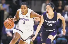  ?? Jessica Hill / Associated Press ?? UConn’s Megan Walker, left, dribbles as Vanguard’s Victoria Chea defends during Sunday’s exhibition game in Storrs.