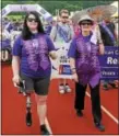  ??  ?? The 2016 Pottstown Relay For Life junior grand marshal Kristen Lawhorne, left, and the grand marshal Donn Piunt lead cancer survivors on the survivor lap as hundreds make their way around the track at Pottsgrove High School Saturday morning.