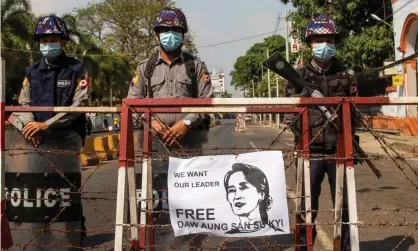  ??  ?? Police stand guard during protests in Yangon on Sunday. Photograph: Reuters