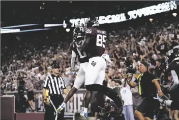  ?? SAM CRAFT/AP ?? TEXAS A&M TIGHT END JALEN WYDERMYER (85) celebrates with wide receiver Ainias Smith (0) after scoring a touchdown agent Alabama during the first half of a game Saturday in College Station, Texas.